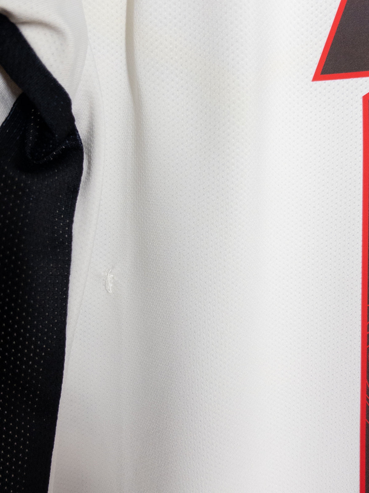 Detalle de la pequeña reparación en la espalda de la camiseta de visita de Alajuelense Kelme 2018 original